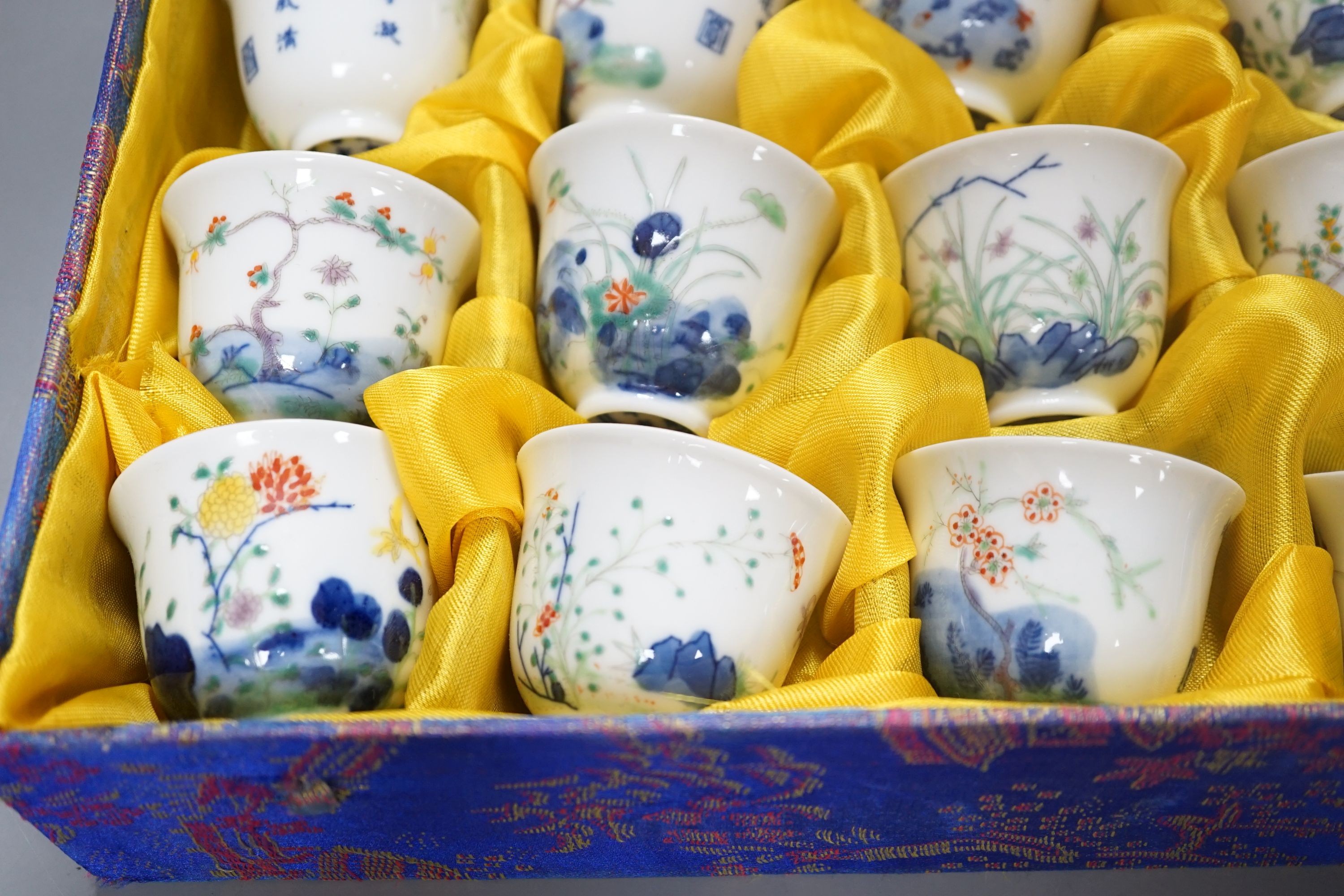 A Chinese boxed set of twelve wucai ‘month’ cups